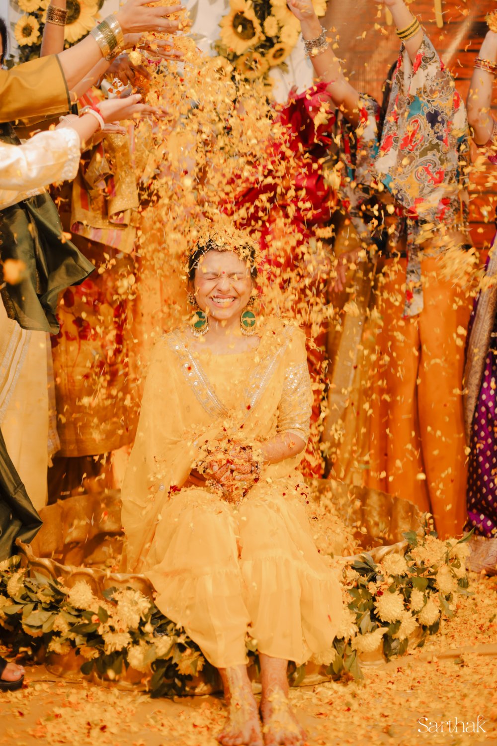 Bride showered with petals at haldi